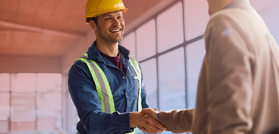 A safety worker is congratulated by leadership and receives merchandise rewards.
